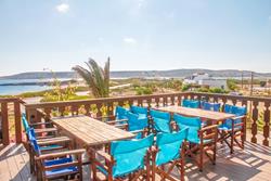 Club Anemos - Karpathos. Bar and restaurant seating, with views over the windsurf sailing area.